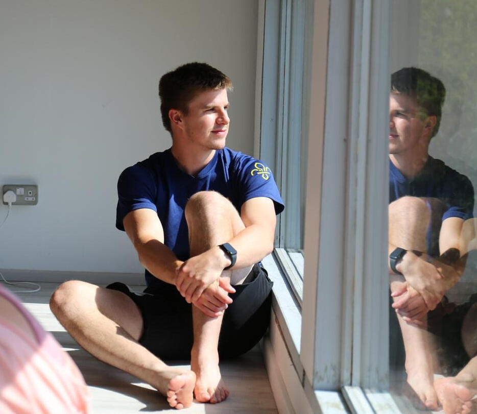 A student pausing to look out over the countryside during a break at Thaxted Wellness Hub, Essex